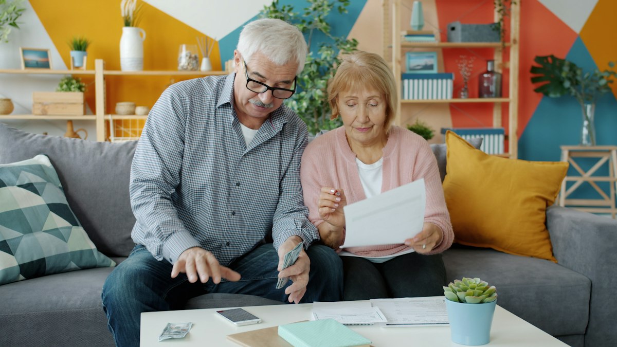 A family working through paperwork together at their kitchen table