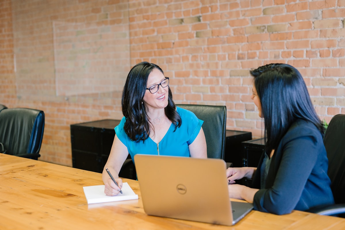 A Harbor Tax advisor reviewing a plan with two clients at a conference table
