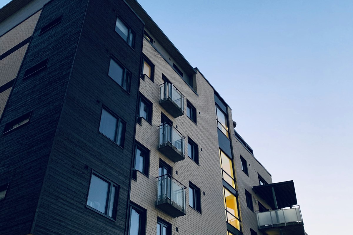 Modern apartment building with balconies on a sunny street