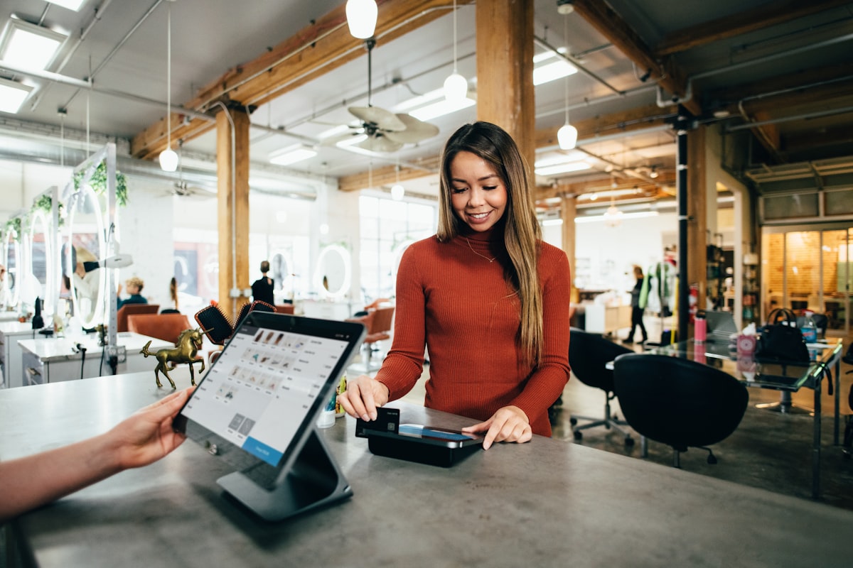 A small business owner standing behind the counter of her café
